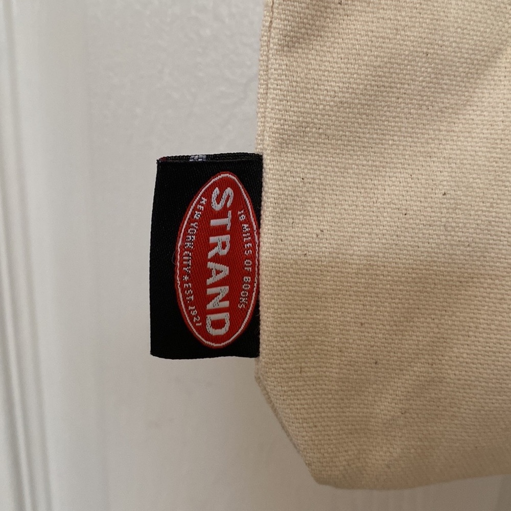 The Strand Icon RBG Time is one the side of CHANGE Tote Bag - Picture 7 of 10